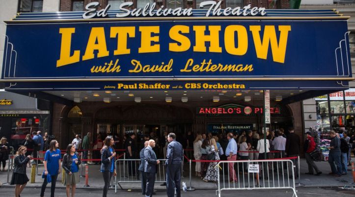NEW YORK, NY - MAY 20:  Fans of David Letterman, members of the media, security agents, passersby and employees of the Late Show gather around the entrance to the Ed Sullivan Theater, where The Late Show with David Letterman is filmed, on May 20, 2015 in New York City. Tonight is the final show with David Letterman as the host. Stephen Colbert is slated to take over the show later this year.  (Photo by Andrew Burton/Getty Images)